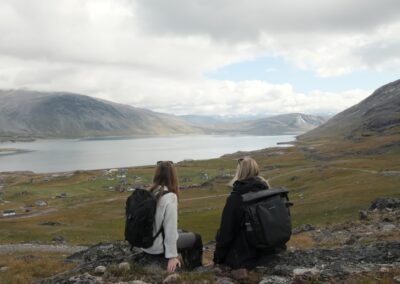 Guests overlooking Greenlandic landscape and small village