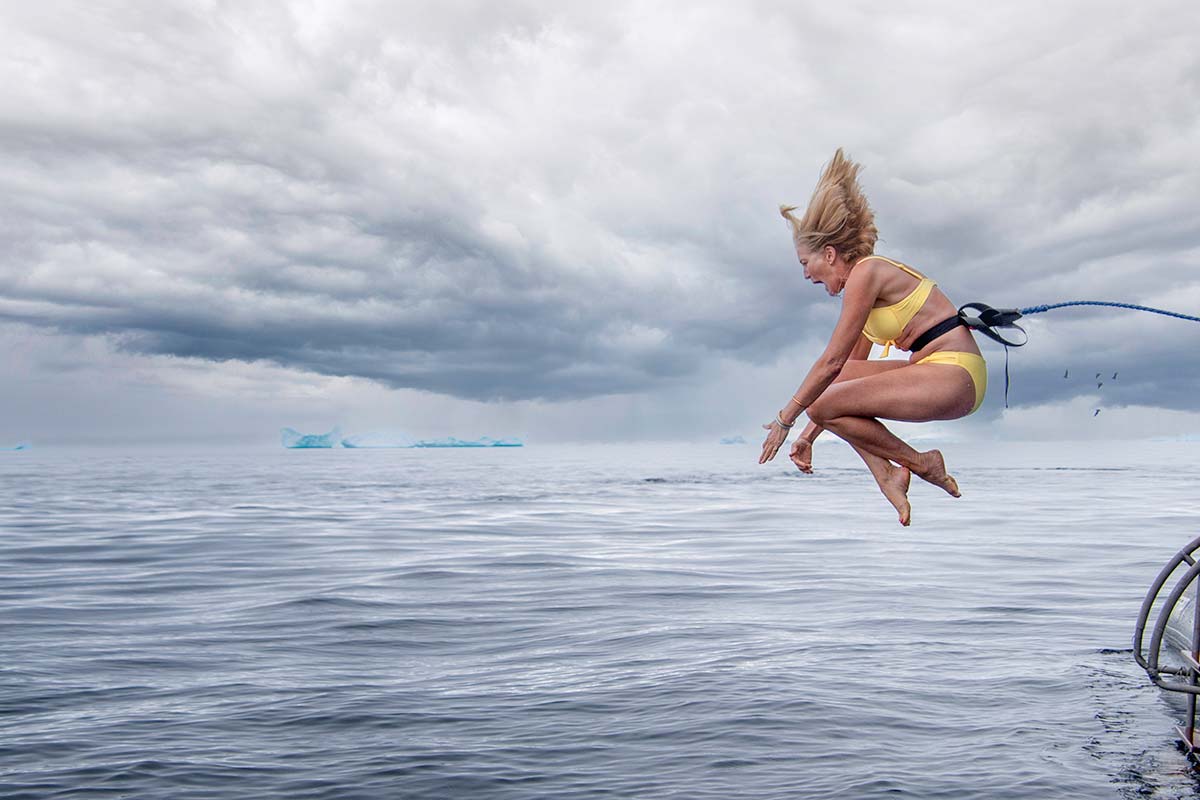 Woman in yellow bikini does the polar plunge in Antarctica