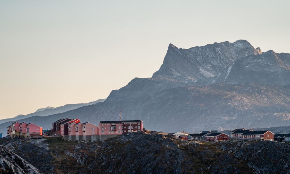Pink homes in Nuuk with Sermitsiaq mountain in background.